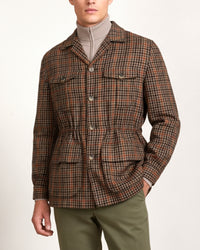 Man wearing a brown check cashmere safari jacket by Justo Gimeno for Santamaria