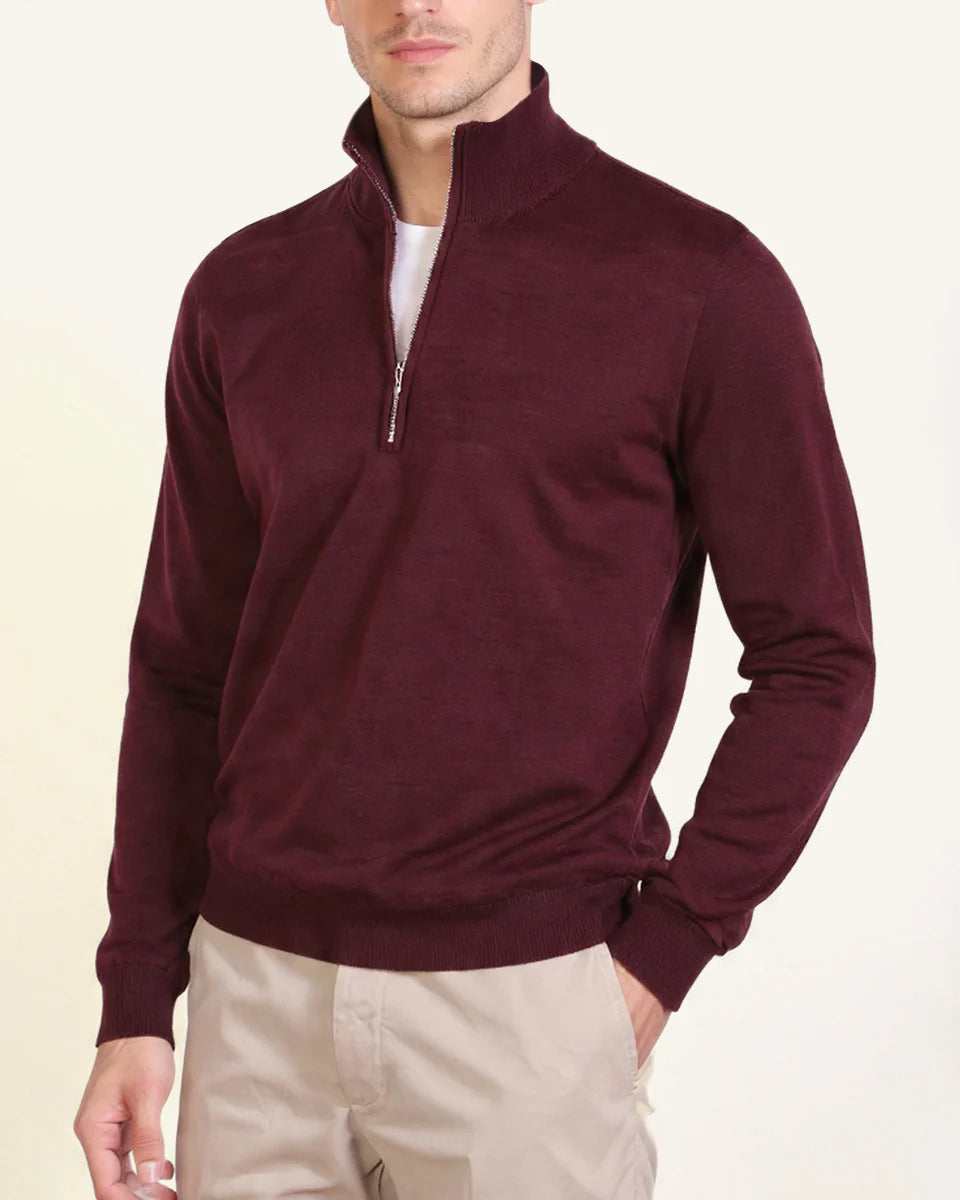 Men's burgundy merino wool quarter-zip jumper worn over a T-shirt with chinos