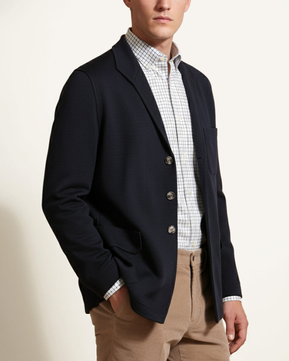 Man wearing a navy knitted cashmere Teba jacket by Justo Gimeno for Santamaria