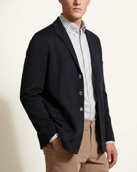 Man wearing a navy knitted cashmere Teba jacket by Justo Gimeno for Santamaria