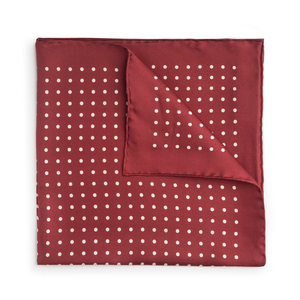 Red silk pocket square with white polka dots and hand-rolled edges